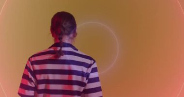 Animation of neon circles over female rugby player on neon background. Sports and communication concept digitally generated video.