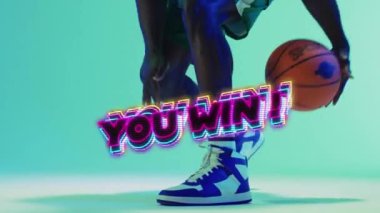 Animation of you win text over basketball player on neon background. Sports, competition and communication concept digitally generated video.