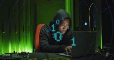 Animation of binary coding over african american male hacker with computer and computer servers. Global online virus, computing and data processing concept digitally generated video.