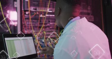 Animation of data processing over african american male it engineer and computer servers. Global computing and data processing concept digitally generated video.