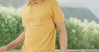 Slow motion video of african american man wearing yellow polo shirt with copy space. Fashion, design and colour concept.