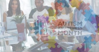 Animation of puzzle and autism awareness month text over diverse students working. Autism awareness month, celebration and digital interface concept digitally generated video.