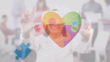 Animation of puzzle and heart over happy biracial woman using vr headset. Autism awareness month, celebration and digital interface concept digitally generated video.