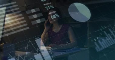 Animation of data processing over biracial businesswoman working in office. Global business, finances, computing and data processing concept digitally generated video.