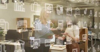 Animation of icons and data processing over diverse business people working in office. Global business, finances, computing and data processing concept digitally generated video.