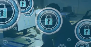 Animation of padlock icons over african american businessman using computer. Global business, finances and digital interface concept digitally generated video.