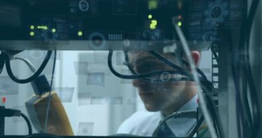 Animation of round scanners and data processing over caucasian male engineer working at server room. Computer interface and business data technology concept