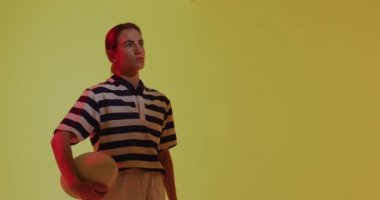 Animation of neon circles over female rugby player on neon background. Sports and communication concept digitally generated video.