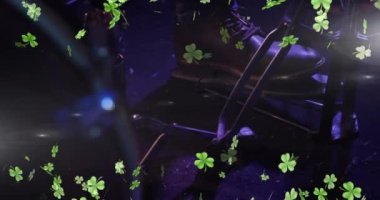 Animation of clover icons over man playing drums. St patrick's day, tradition and celebration concept digitally generated video.