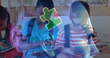 Animation of puzzle and autism awareness month text over diverse schoolchildren using tablet. Autism awareness month, celebration and digital interface concept digitally generated video.