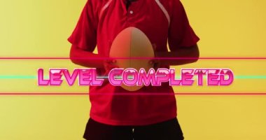 Animation of level completed text over female rugby player on neon background. Sports and communication concept digitally generated video.