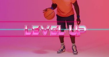 Animation of level up text and neon lines over basketball player on neon background. Sports, competition and communication concept digitally generated video.