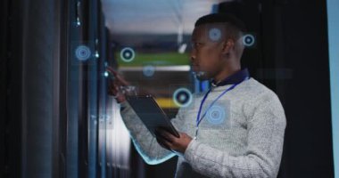 Animation of data processing over african american male it engineer and computer servers. Global computing and data processing concept digitally generated video.