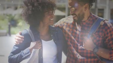 Animation of light spots over diverse couple, slow motion. Valentine's day and love concept digitally generated video.