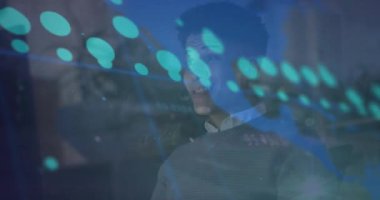 Animation of data processing over biracial businessman working in office. Global business, finances, computing and data processing concept digitally generated video.