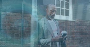 Animation of screens with data processing over african american man using smartphone on street. Global economy and business interface technology concept