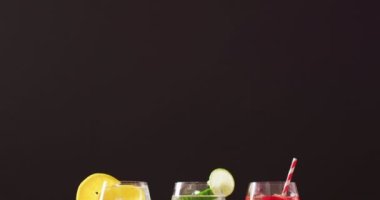 Close up of drinks with fruit on wooden board, with copy space. Cocktail day, party and celebration concept.