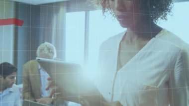 A businesswoman is using a digital tablet in her office, looking at global financial statistics. Global business data processing and digital interface concept digitally generated video.