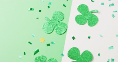 Video of st patrick's green shamrock leaves with copy space on green to white background. St patrick's day, irish tradition and celebration concept.