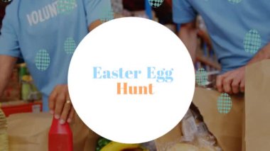 Animation of easter egg hunt text on spot over diverse volunteers in warehouse. Global business and digital interface concept digitally generated video.