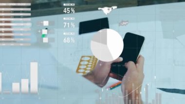 Animation of statistical data processing against rear view of a man using smartphone. Business data technology concept