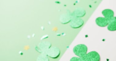 Video of st patrick's green shamrock leaves with copy space on green to white background. St patrick's day, irish tradition and celebration concept.