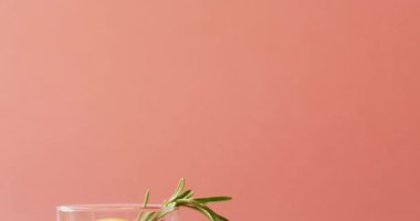 Close up of drink with grapefruit on pink background. Cocktail day, party and celebration concept.