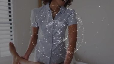 Animation of globe of connections over diverse doctor and patient exercising. Medicine, healthcare and lifestyle concept digitally generated video.