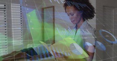 Animation of financial data processing over african american female doctor taking notes. Medicine, healthcare and lifestyle concept digitally generated video.