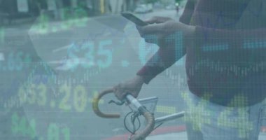 Animation of stock market data processing against mid section of a man with bicycle using smartphone. Global economy and business interface technology concept