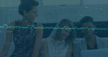 Animation of data processing over diverse colleagues smiling together looking at laptop at office. Global finance and business technology concept