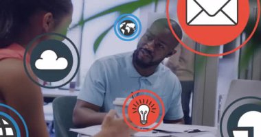 Animation of social media icons and data processing over diverse business people. Global networks, business, finances, computing and data processing concept digitally generated video.