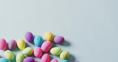 Multiple colorful easter eggs on green background with copy space. Easter, tradition and celebration concept.