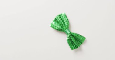 Video of st patrick's green bow tie with copy space on white background. St patrick's day, irish tradition and celebration concept.