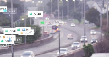 Animation of notification icons with counters over slow motion of cars moving on street in city. Digital composite, multiple exposure, social media, speech bubble, number, transportation.