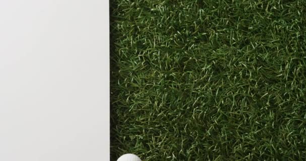 Close Golf Ball Grass White Background Copy Space Slow Motion — Stockvideo