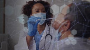 Animation of shapes and connections over diverse doctor and patient taking swab test. Medicine, healthcare and lifestyle concept digitally generated video.