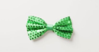 Video of st patrick's green bow tie with copy space on white background. St patrick's day, irish tradition and celebration concept.