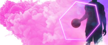 Midsection of african american male player holding basketball by hexagon over smoky background. Hand, copy space, composite, illuminated, sport, competition, illustration, shape and abstract concept.