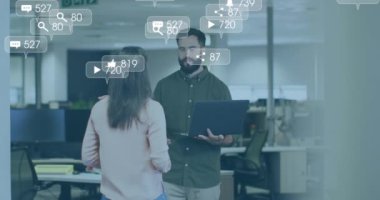 Animation of financial data processing over diverse business people using laptop in office. Global business, finances, computing and data processing concept digitally generated video.