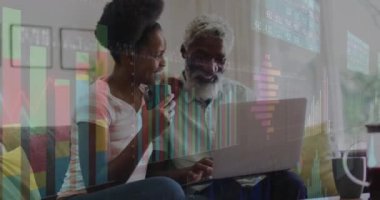 Animation of financial data processing over african american father and adult daughter using laptop. Finances, lifestyle and digital interface concept digitally generated video.