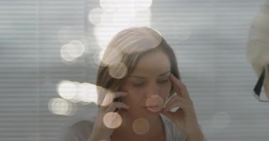 Animation of light spots over caucasian woman consulting psychologist. Mental health, therapy and healthcare concept digitally generated video.