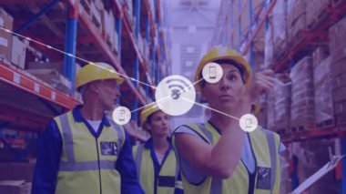 Animation of network of connections with icons over diverse workers in warehouse. Global connections, delivery, shipping and digital interface concept digitally generated video.
