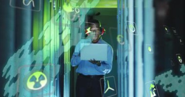 Animation of eco icons and data processing over african american it technician by servers. Global computing and data processing concept digitally generated video.