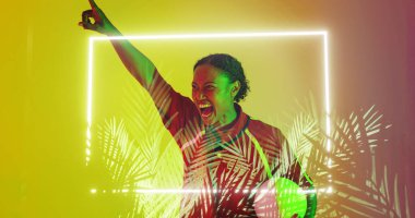 Composite of illuminated square and plants over happy african american female rugby player screaming. Copy space, digital composite, nature, shape, sport, competition, winning, match, abstract.