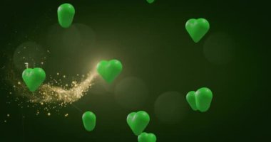 Animation of st patrick's day text and green hearts on green background. St patrick's day, irish tradition and celebration concept digitally generated video.
