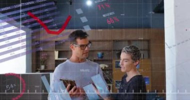 Animation of financial data processing over diverse business people using technological devices. Global business, finances and digital interface concept digitally generated video.