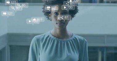 Animation of social media icons and data processing over biracial businesswoman. Global business, finances, computing and data processing concept digitally generated video.