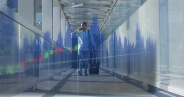 Animation of financial data processing over biracial businessman in airport. Global travel, business, finances, computing and data processing concept digitally generated video.