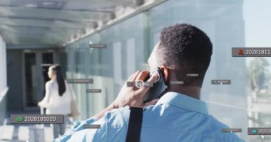 Animation of financial data processing over biracial businessman in airport. Global travel, business, finances, computing and data processing concept digitally generated video.